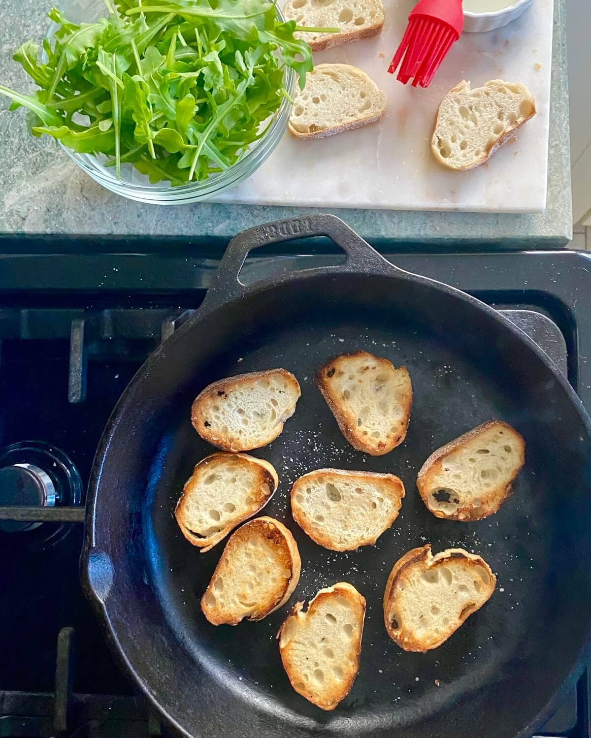 Crostini in a cast iron skillet.