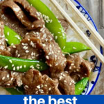 beef stir fry in a bowl over rice with chopsticks