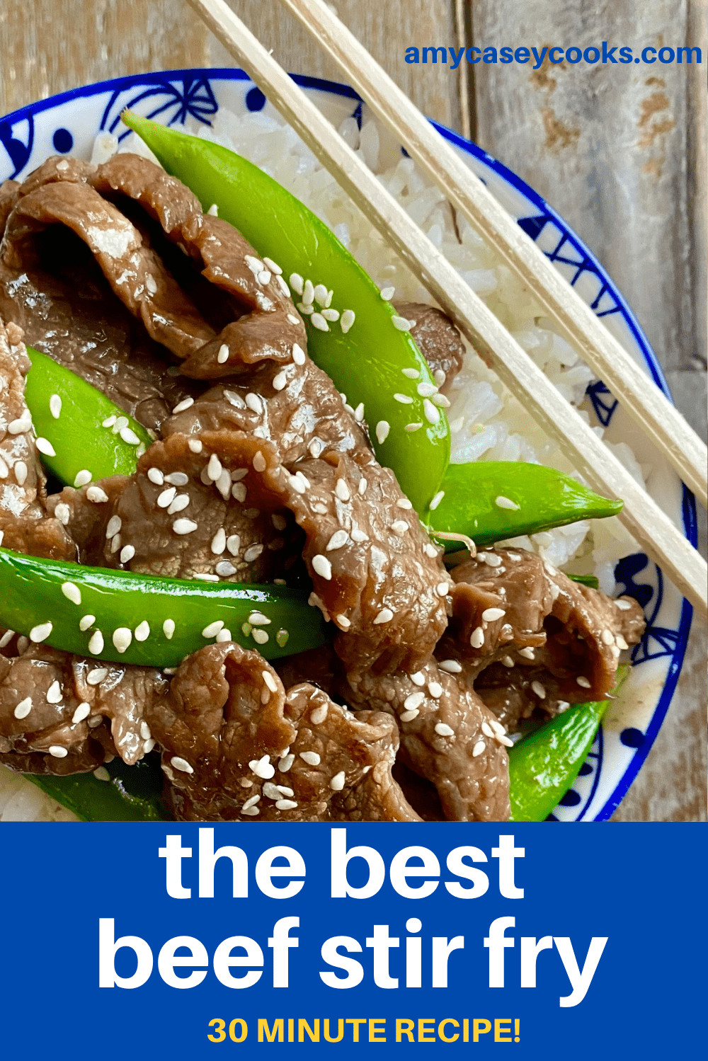 beef stir fry in a bowl over rice with chopsticks