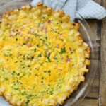 A hash brown crust quiche cooling on a rack.