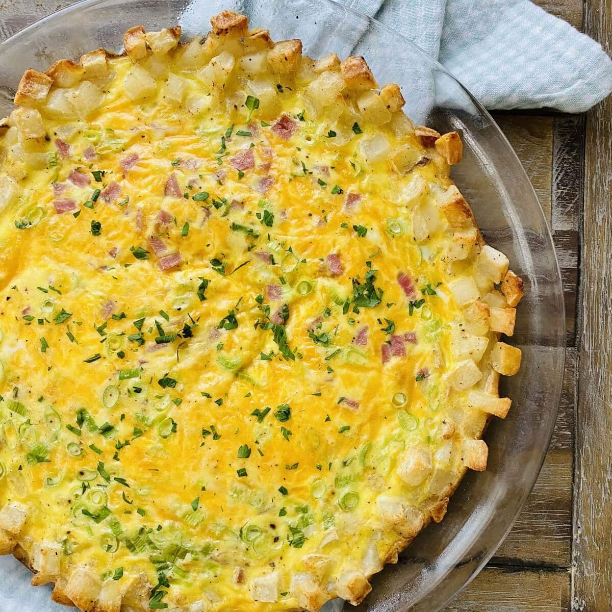 A hash brown crust quiche cooling on a rack.