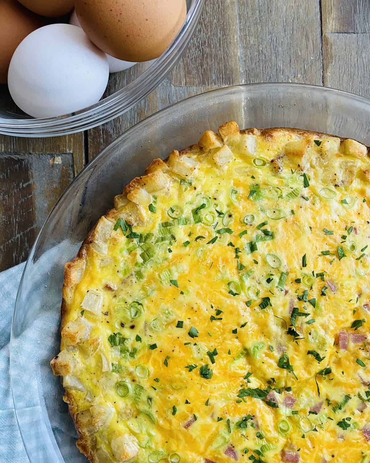 A whole hash brown crust quiche with ham and cheddar.