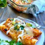 A plate with 2 black bean enchiladas.