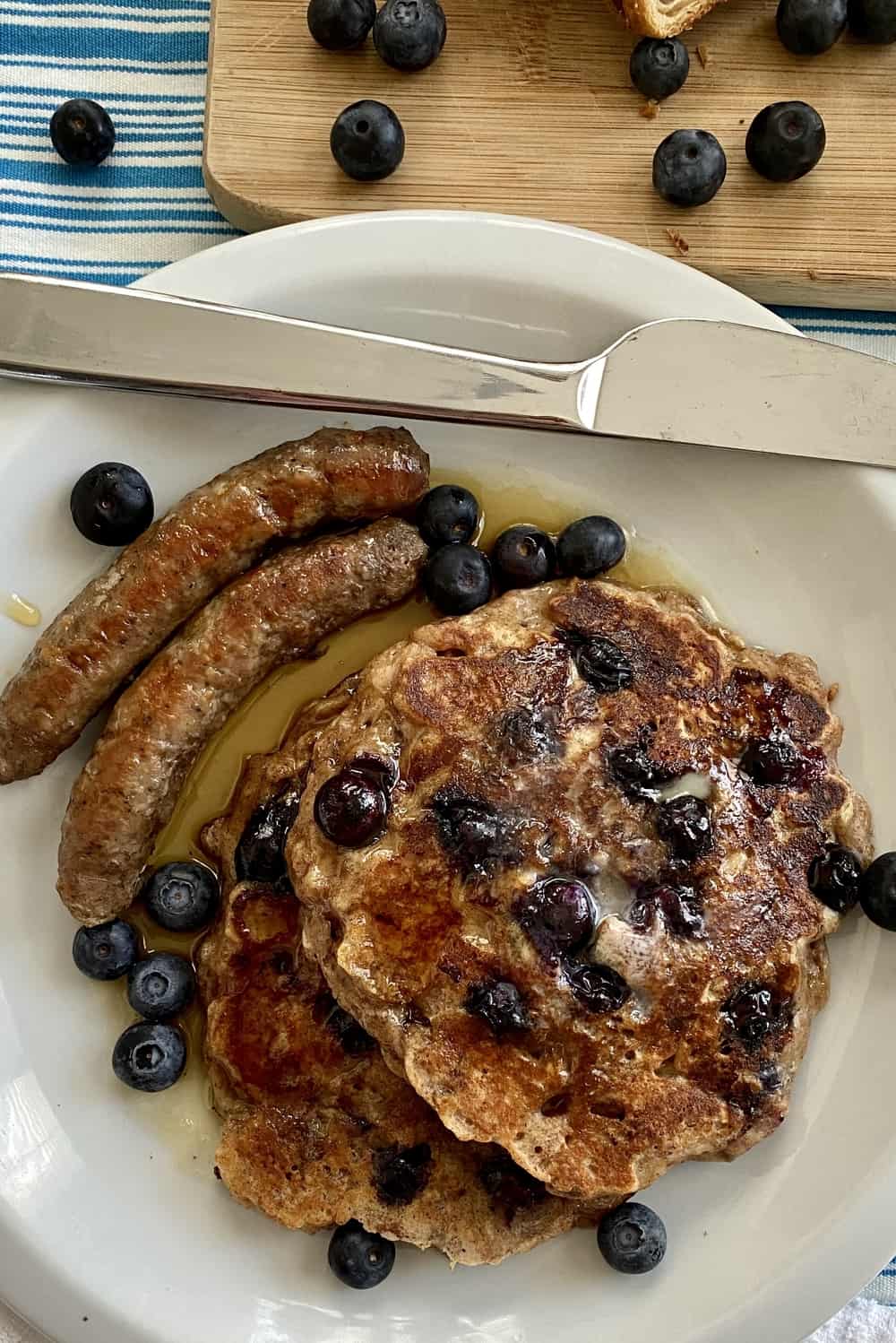 stack of blueberry bread pudding pancakes with sausage