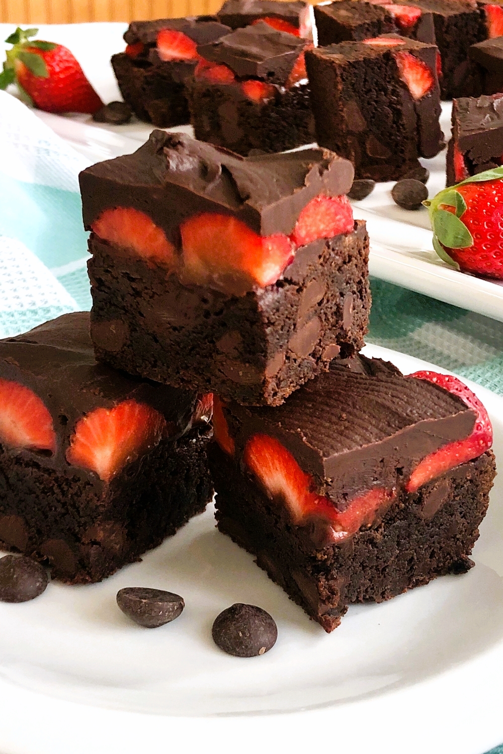 3 chocolate covered strawberry brownies stacked on top of each other