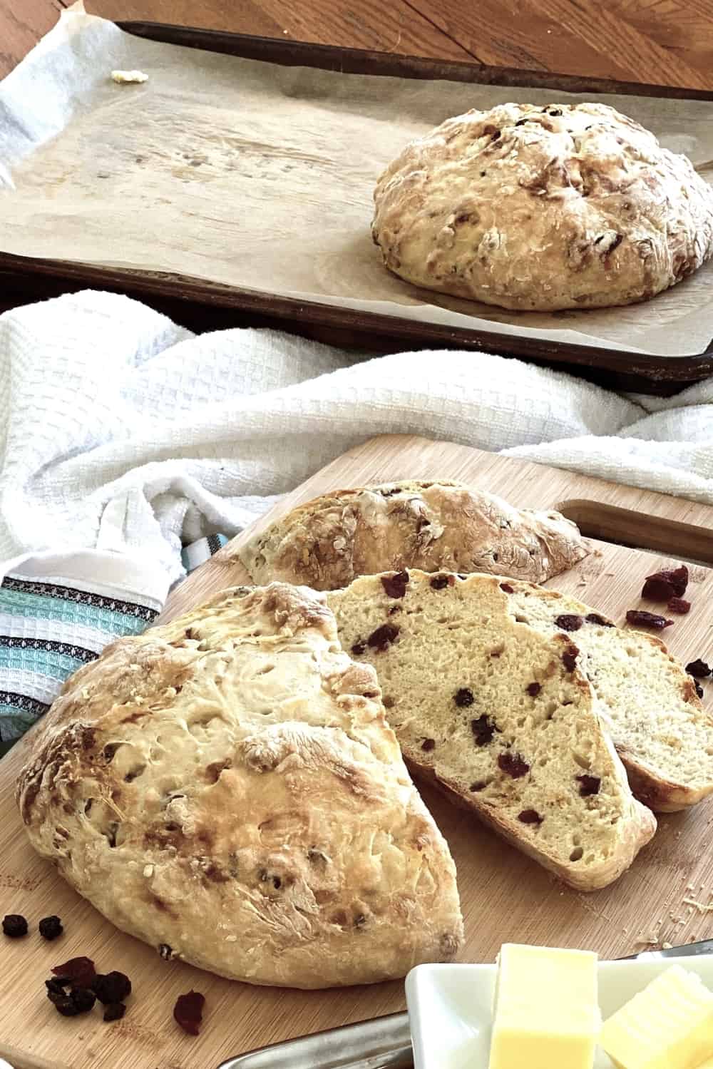A sliced loaf of soda bread with cranberries and currants.