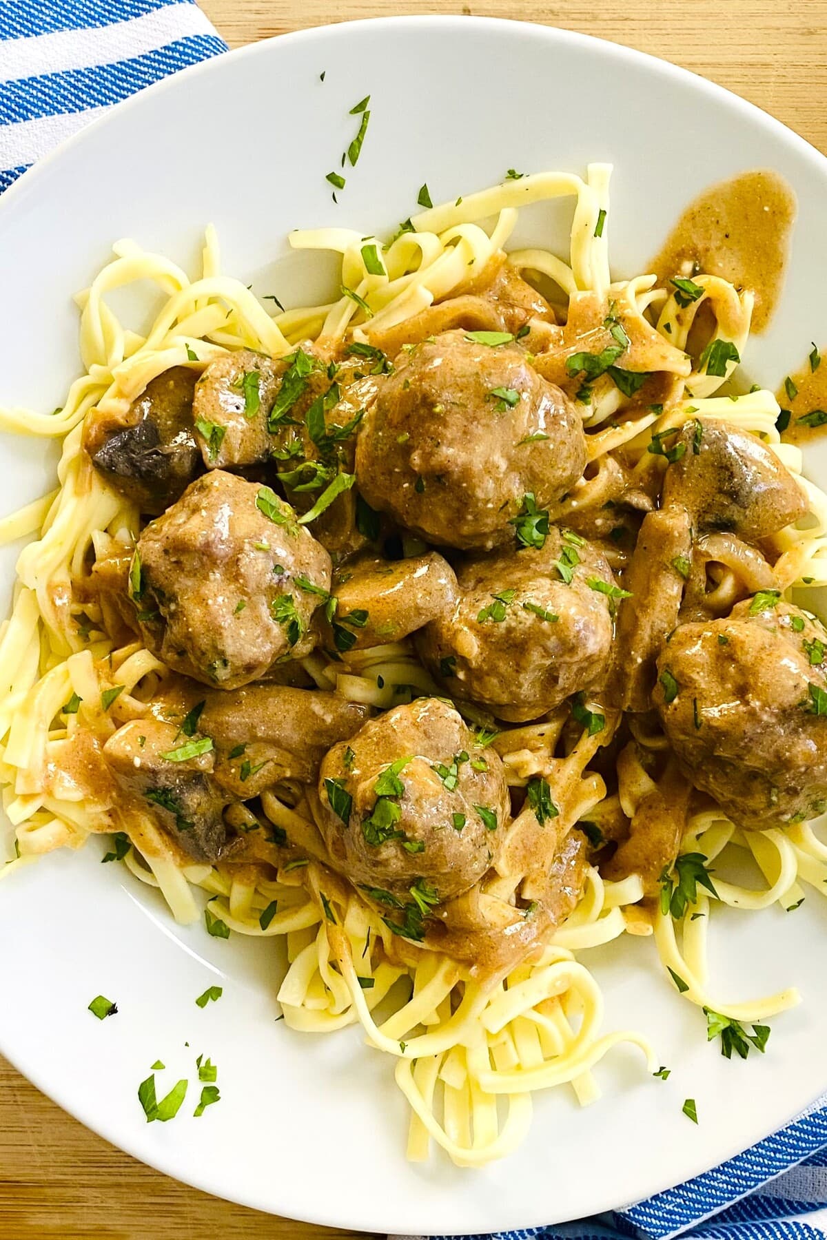 Saucy meatballs with stroganoff gravy on top of noodles.