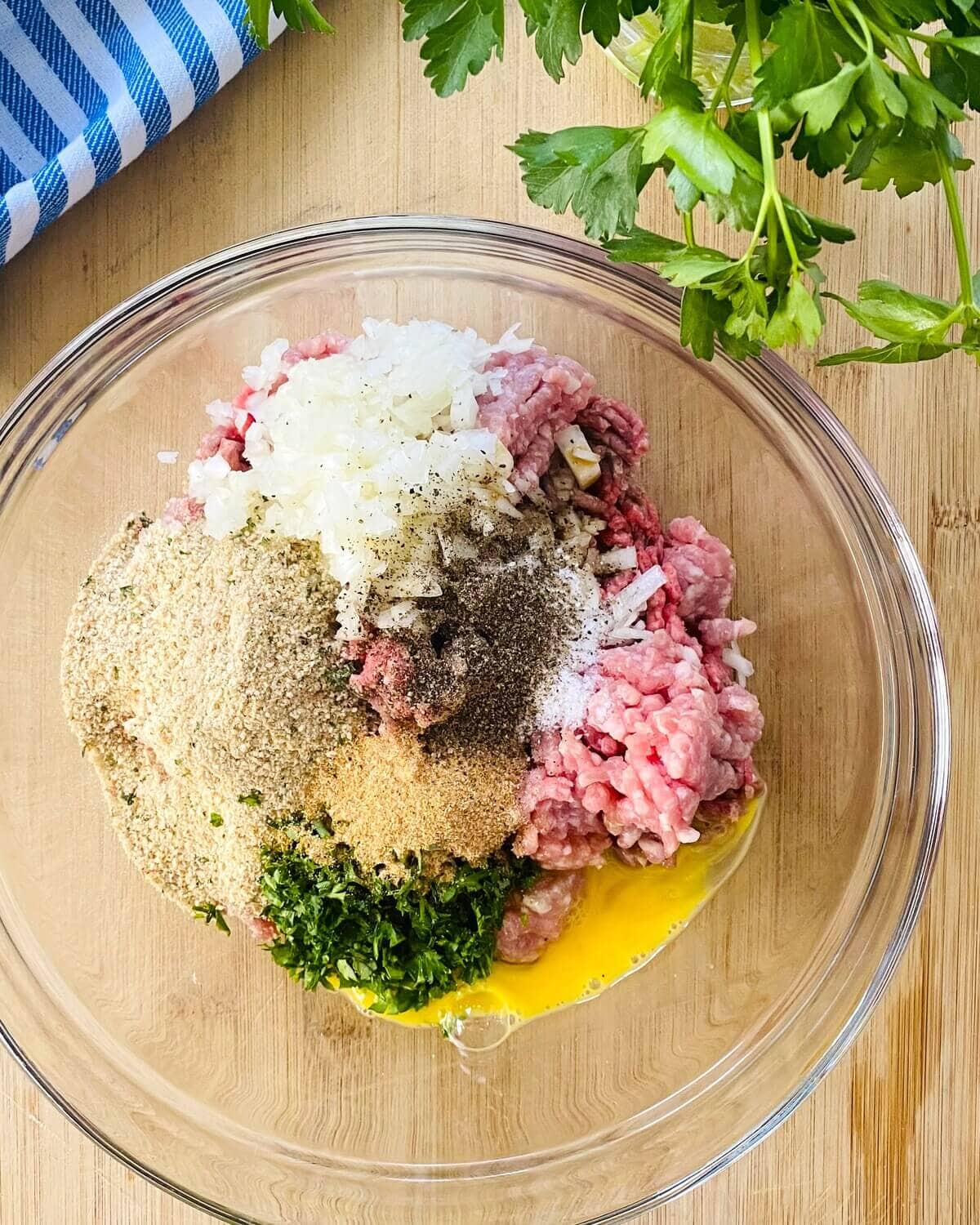 The ingredients for meatballs in a bowl.