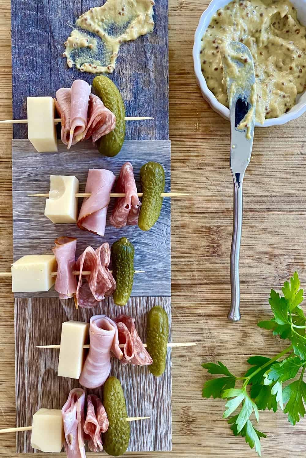 Cuban sandwich appetizer skewers with ham, Swiss cheese, salami and dill pickle