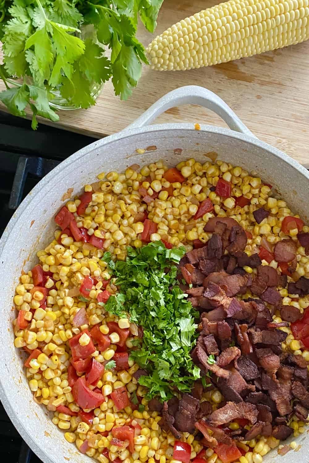 Adding herbs and to fresh corn salad.