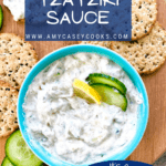 dish of tzatziki sauce with crackers and cucumbers