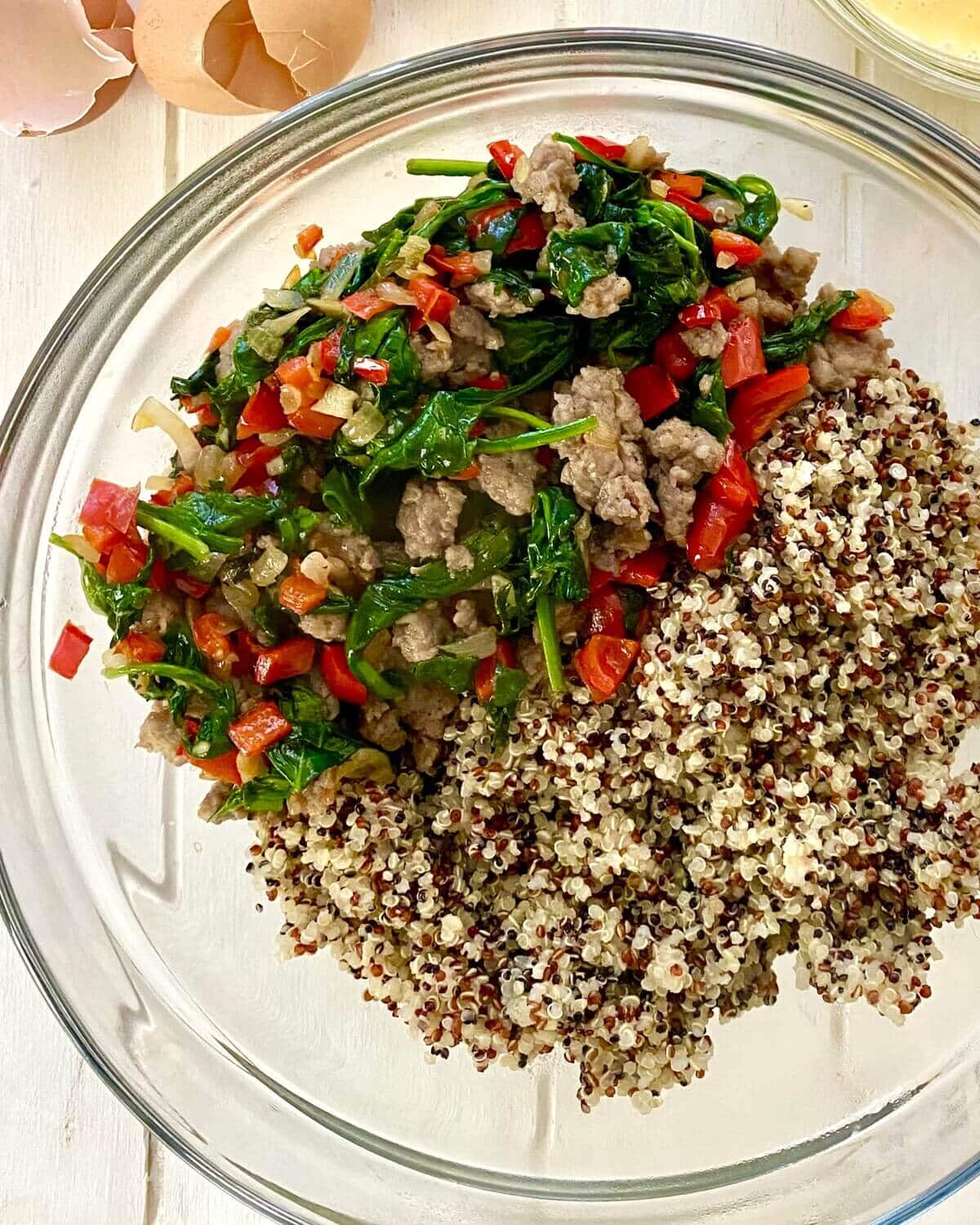 Cooked quinoa with sauteed vegetables and breakfast sausage.