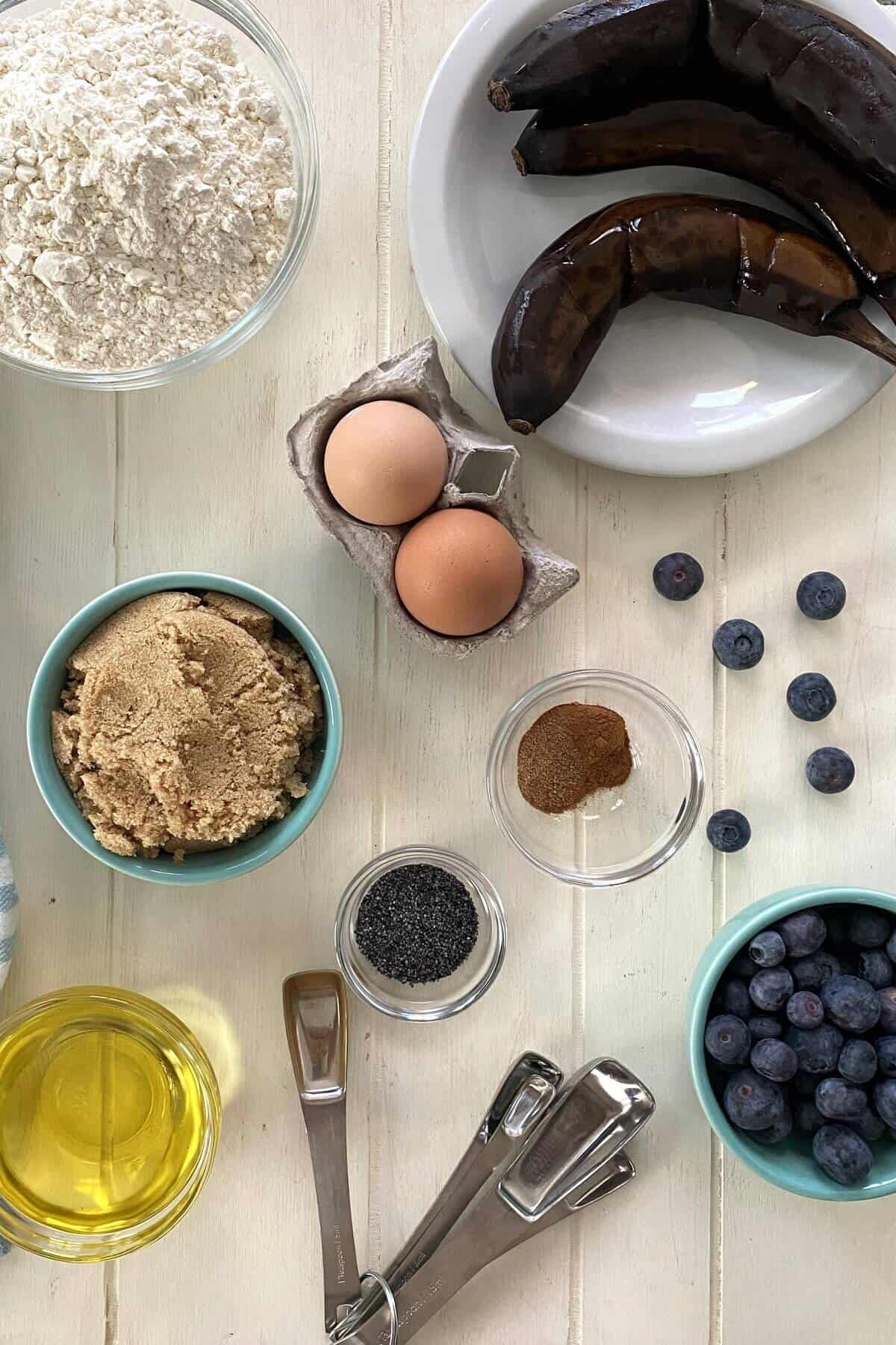 black bananas, flour, brown sugar, eggs, blueberries, olive oil, poppy seeds.
