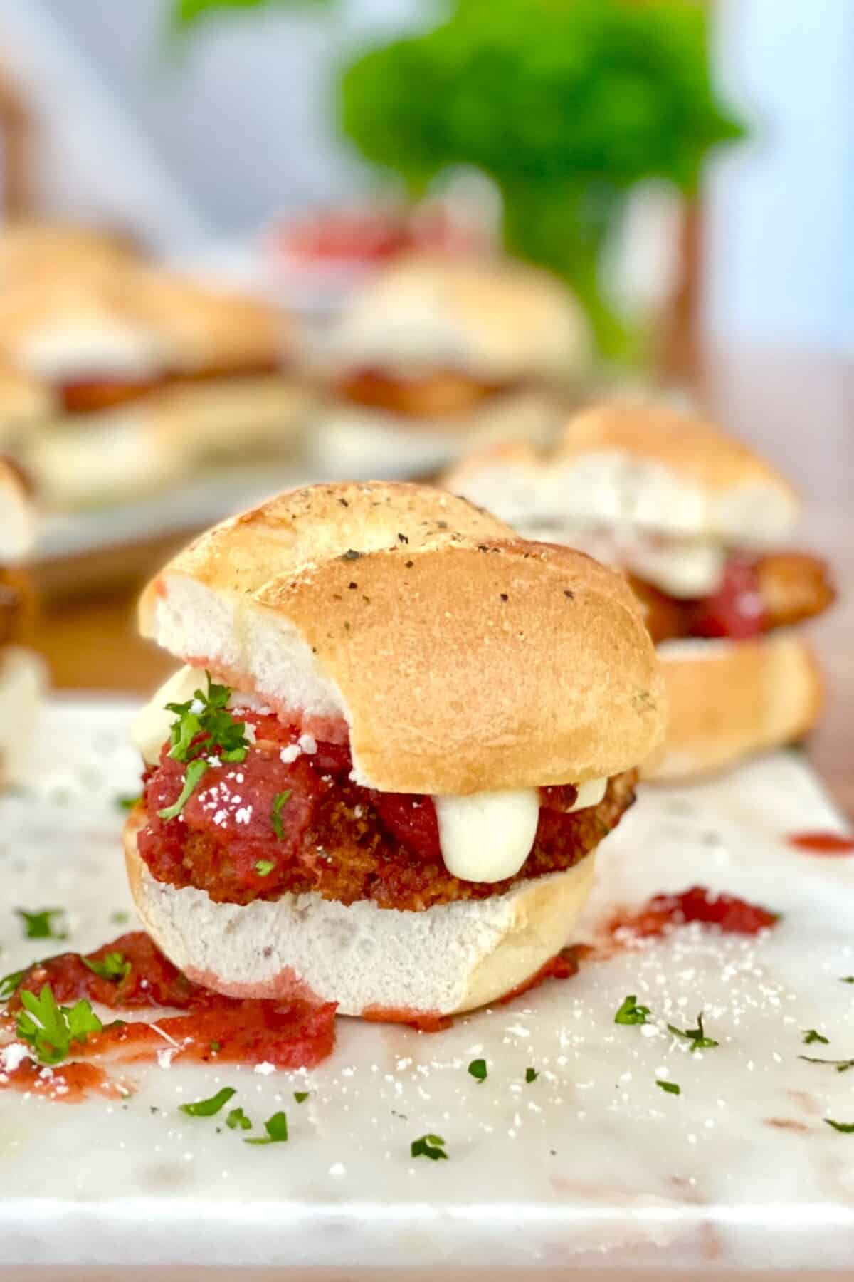 mini chicken parm sandwich with melted mozzarella cheese.
