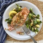 a piece of stuffed salmon with brussels sprouts.