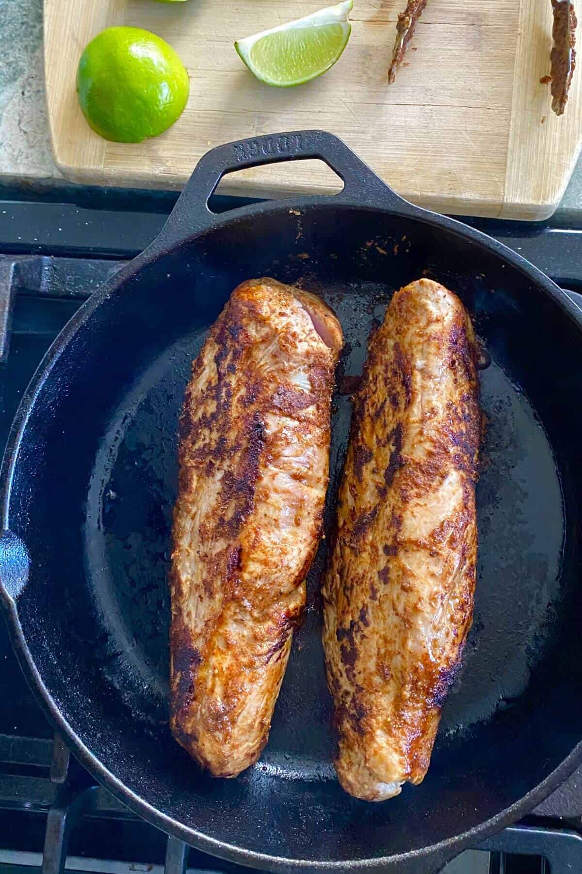 searing pork in a cast iron skillet.