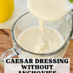 Caesar dressing drizzle off a spoon.