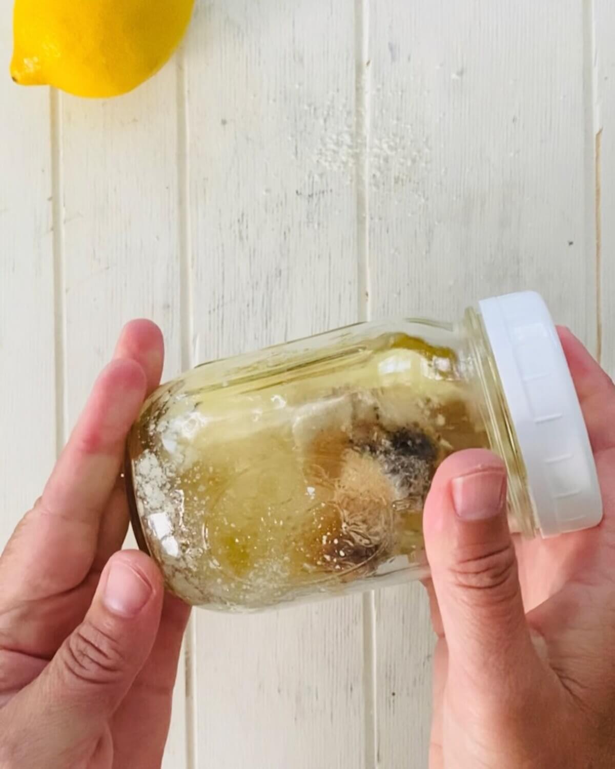 mason jar with Caesar salad dressing ingredients.