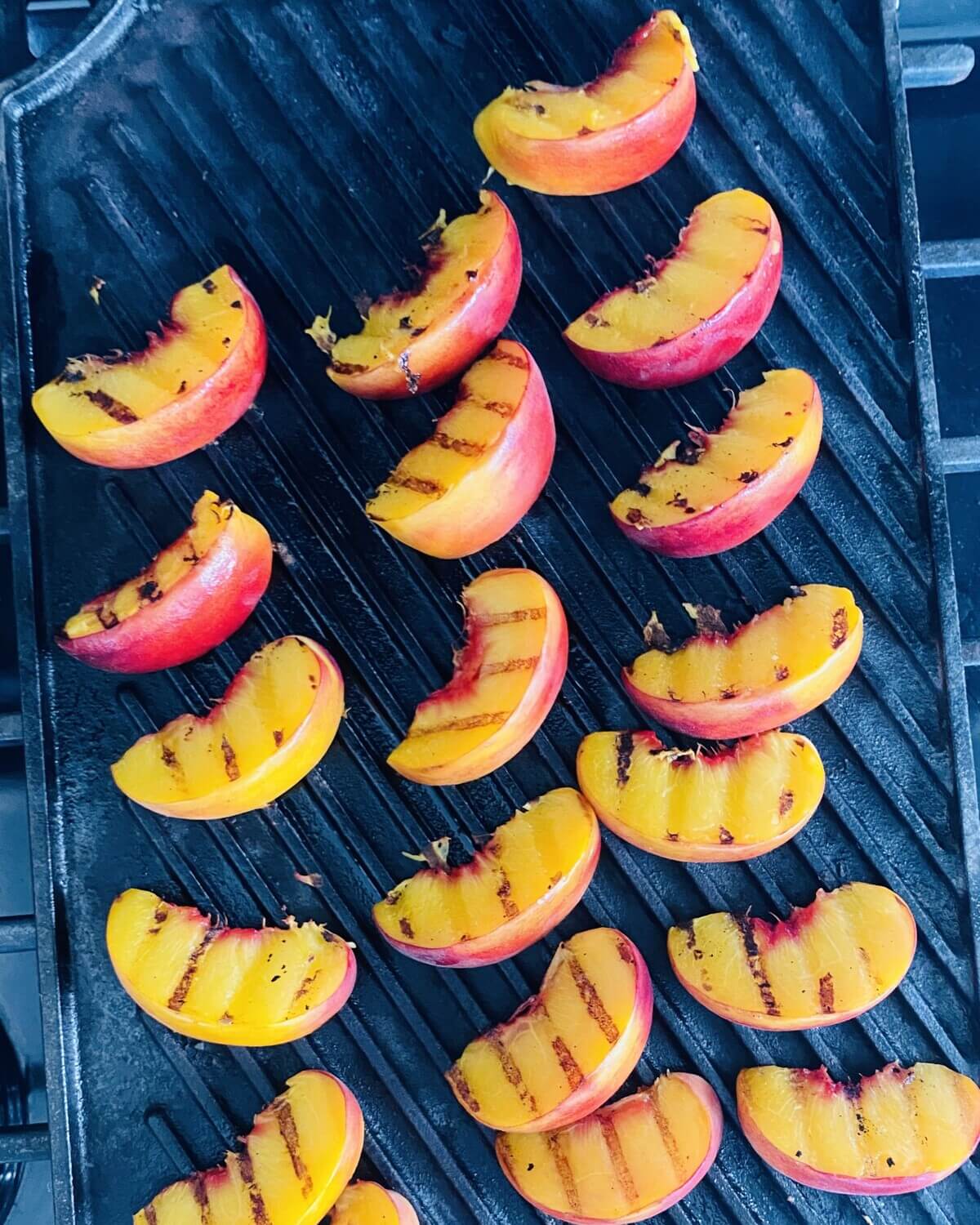 grilling peaches on a grill pan.