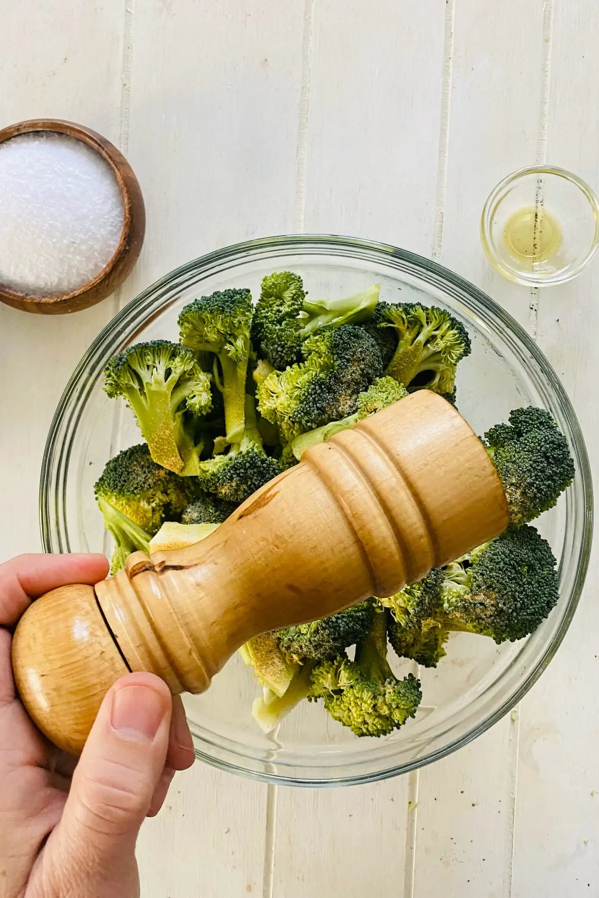 a peppermill and raw broccoli.