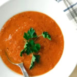 A bowl of tomato bisque with basil.
