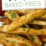 Plate with crispy oven fries and ketchup and chopped parsley.