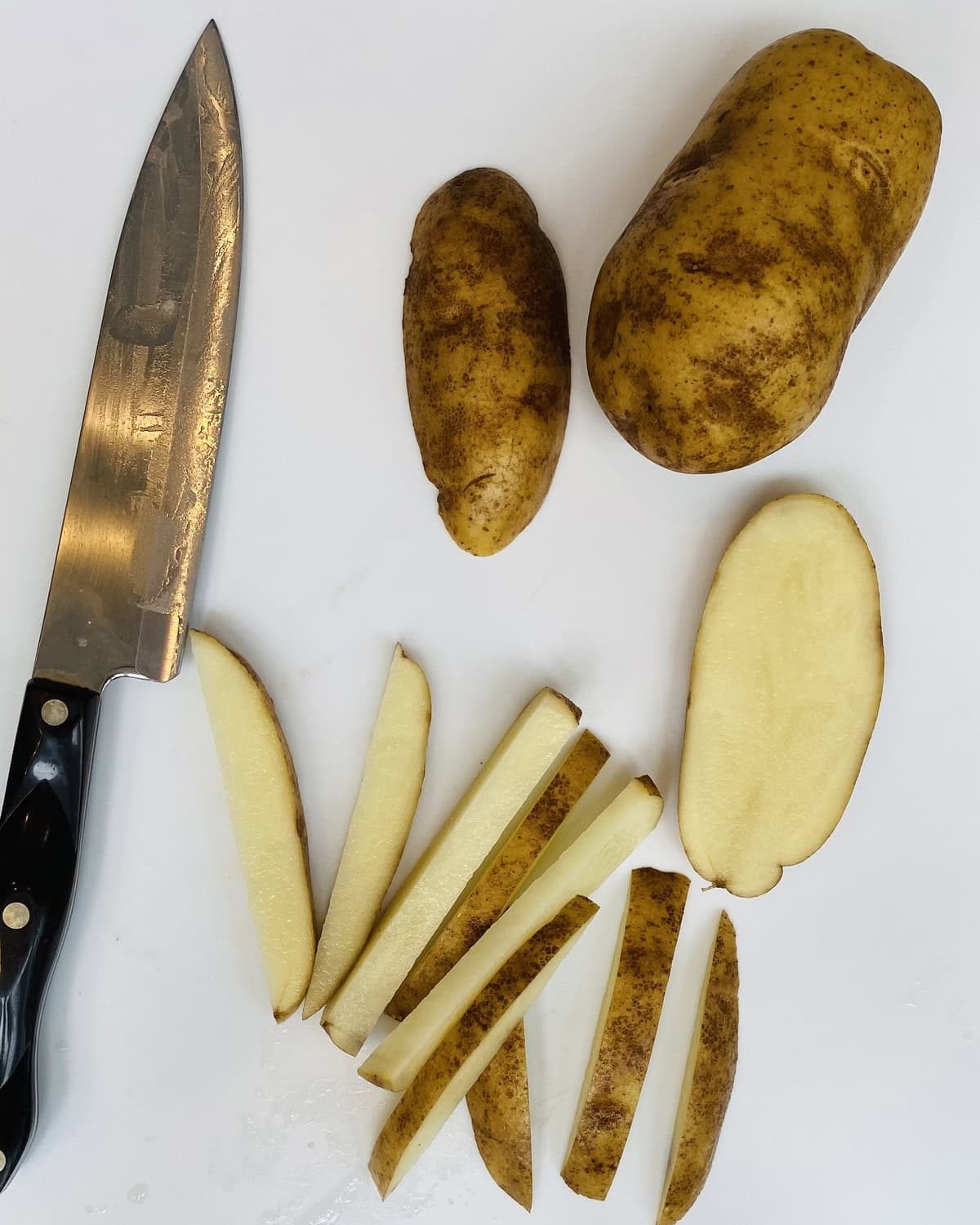 Cut russet potato and a knife.