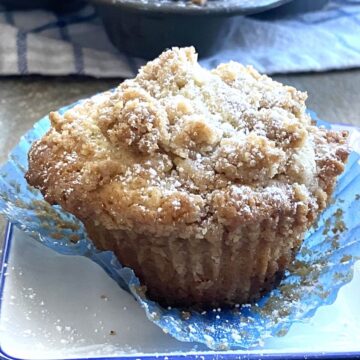 A single coffee cake muffin with the paper removed.