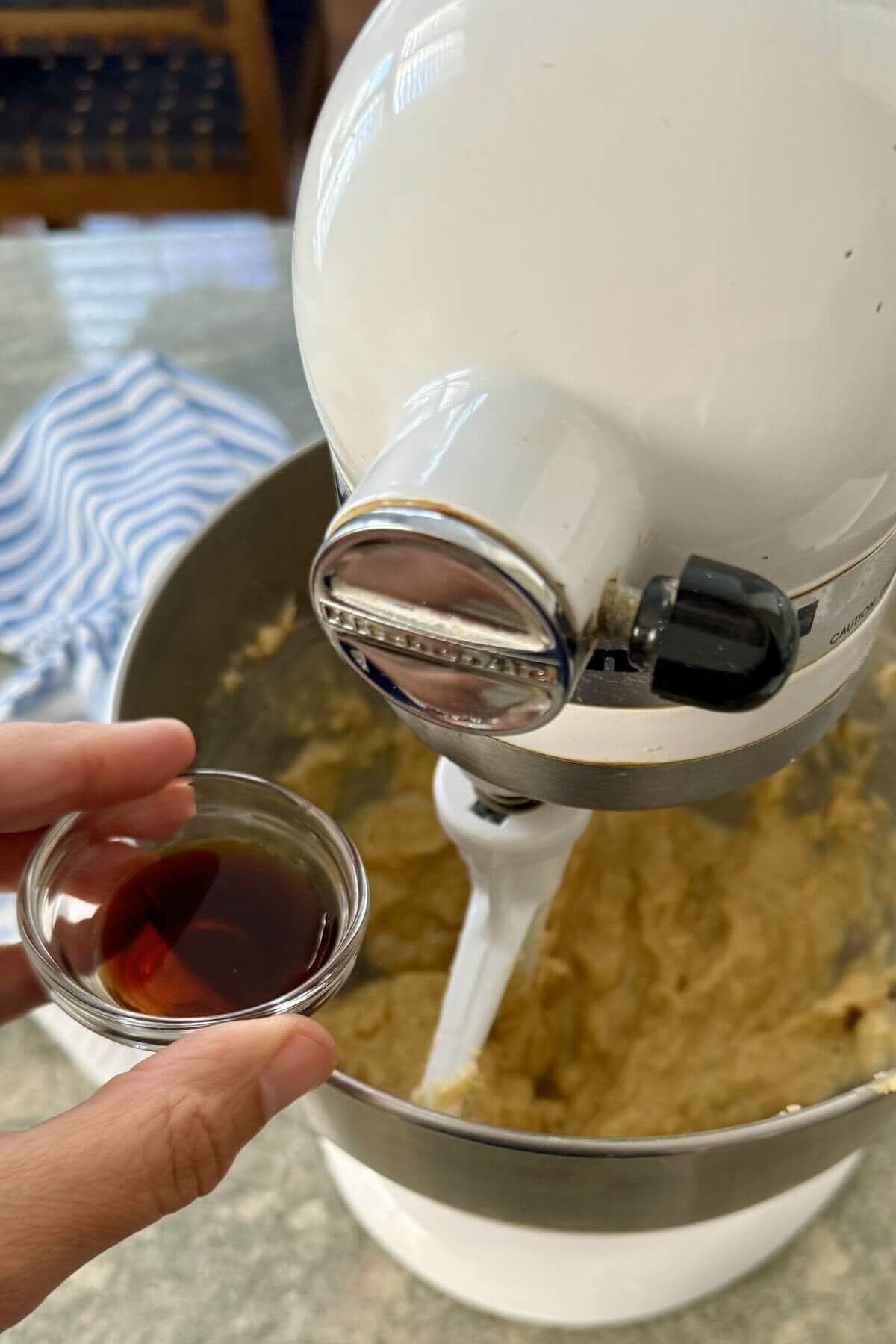 Adding vanilla to cookie batter.