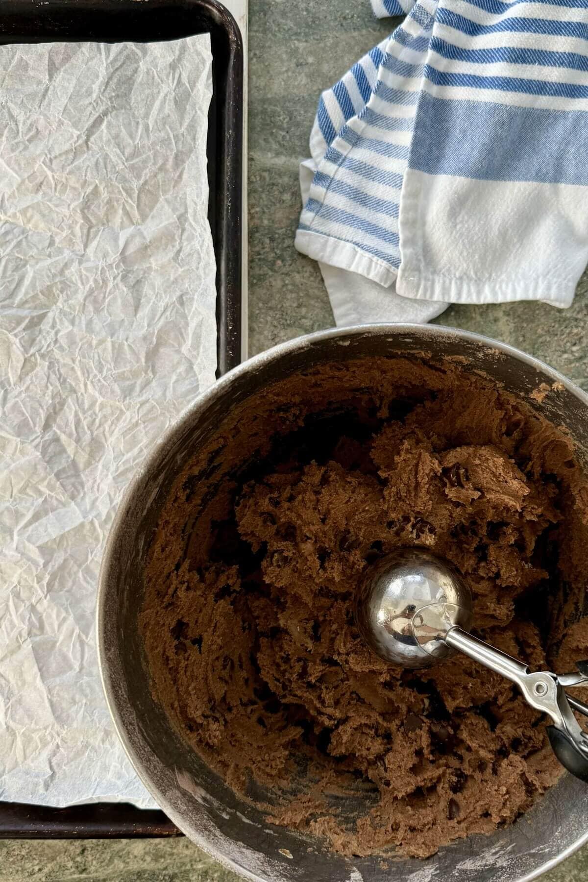A large cookie scoop and cookie dough.