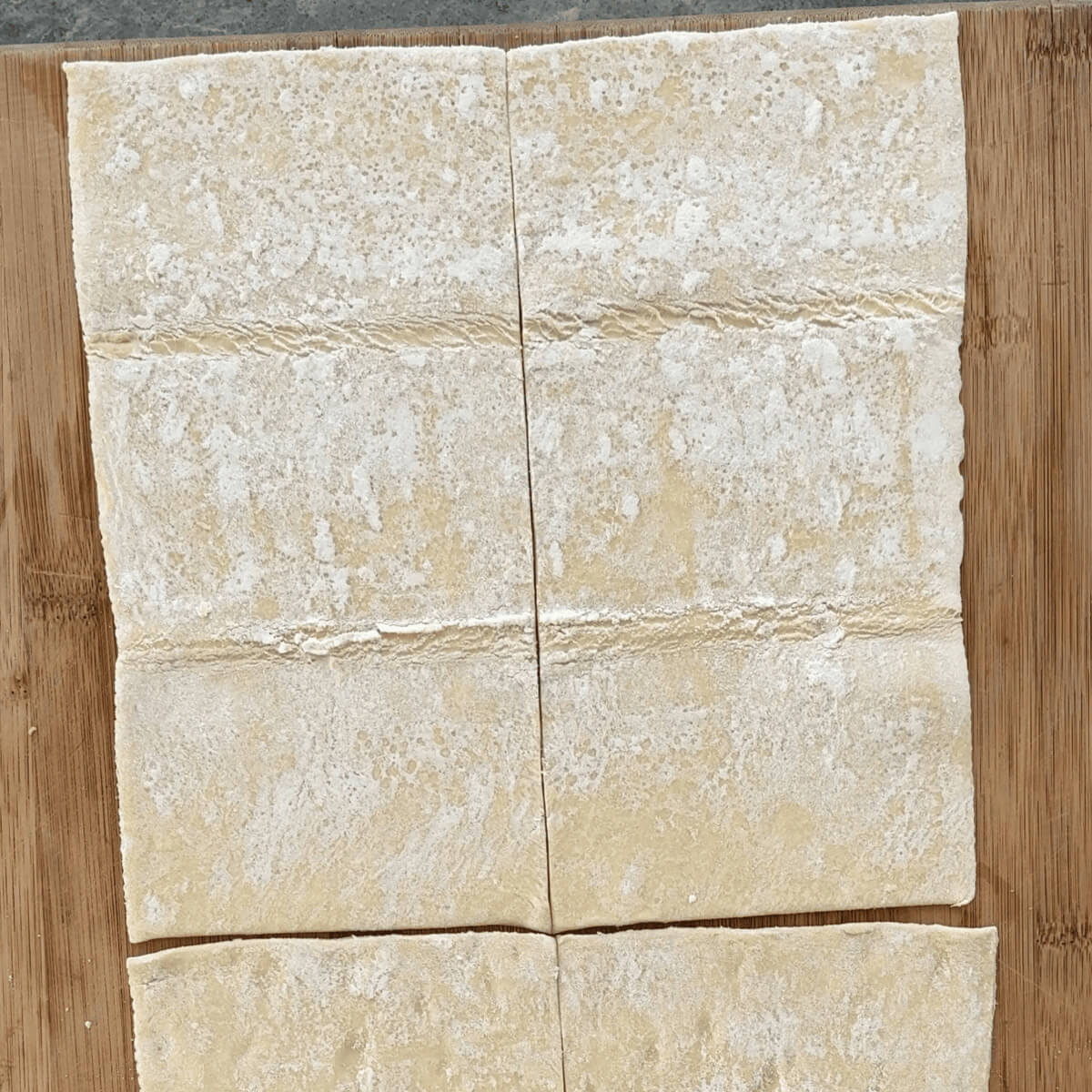 Puff pastry on a cutting board.