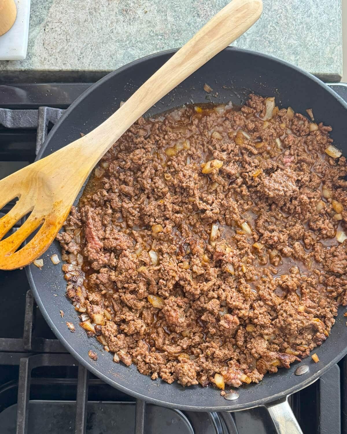 Cooked ground beef in a skillet.