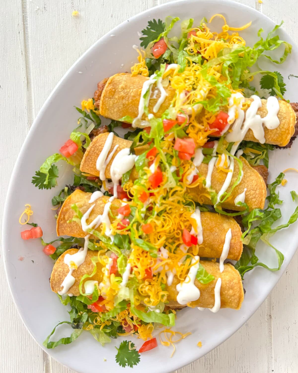 Rolled tacos on a plate.