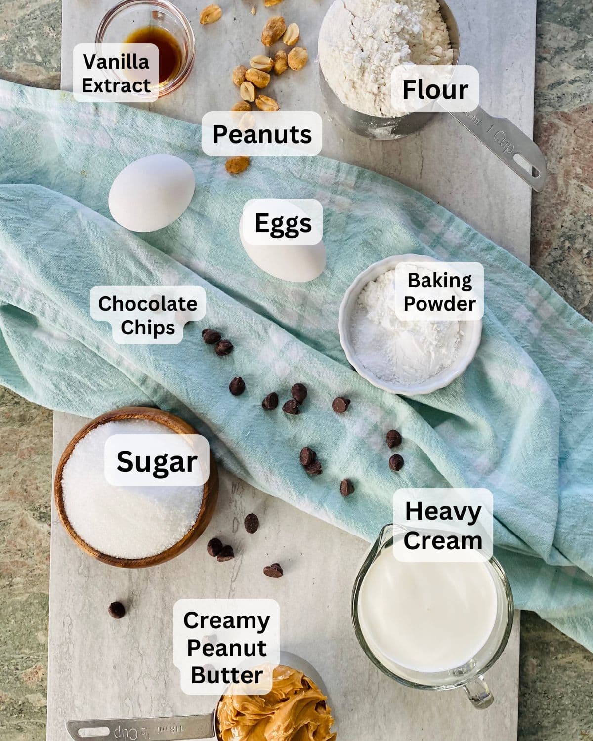 Flour, eggs, peanut butter, chocolate chips, sugar, and cream for peanut butter bread recipe.