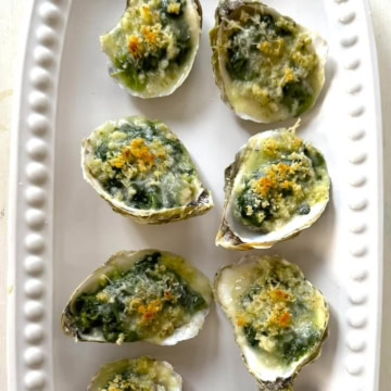 Baked and plated oysters Rockefeller.