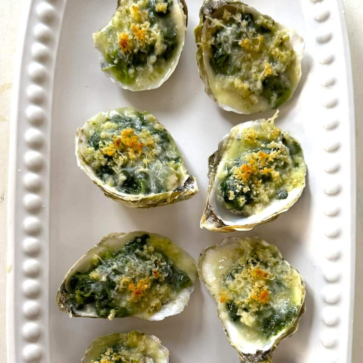 Baked and plated oysters Rockefeller.