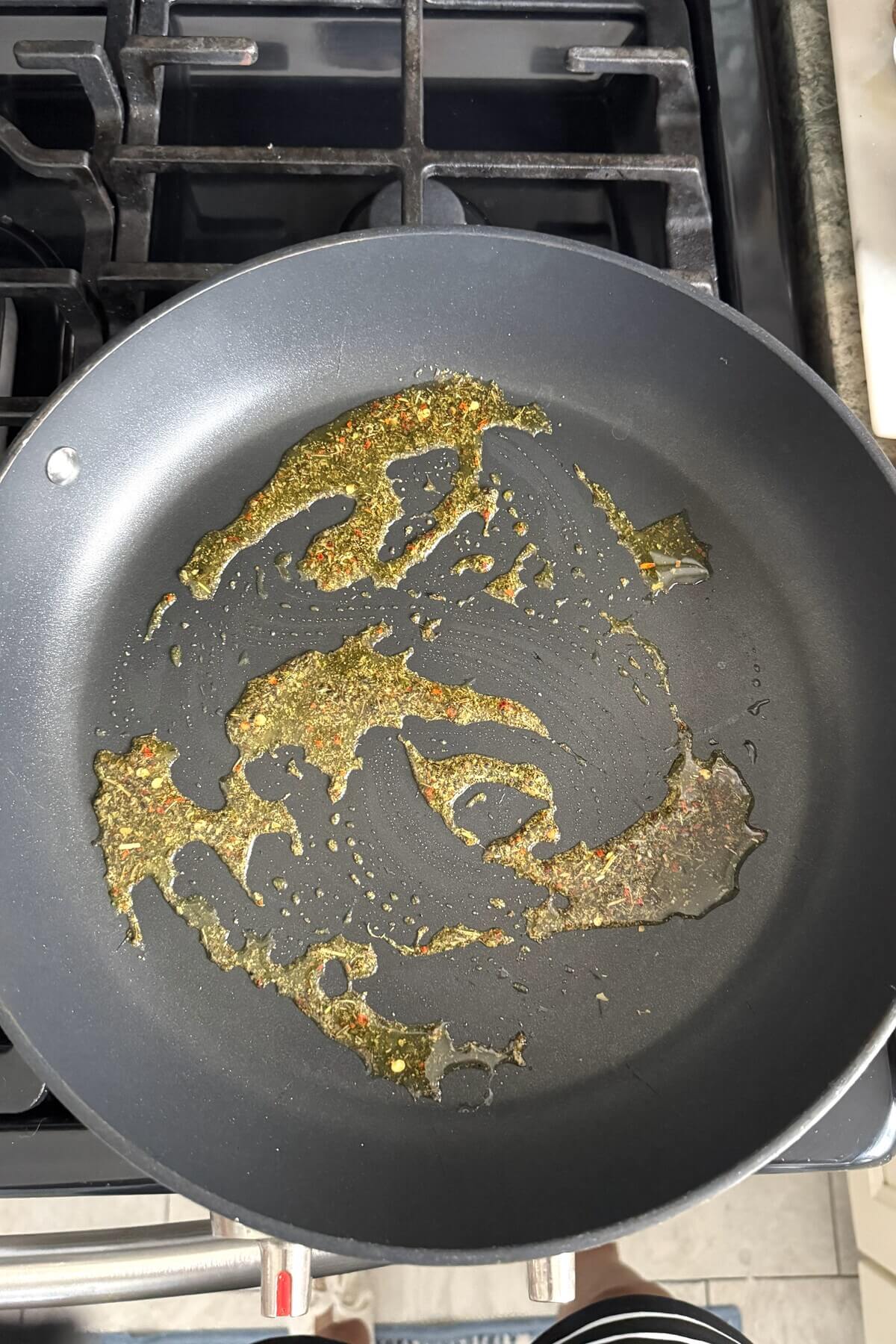 Sauteing dried spices in olive oil.
